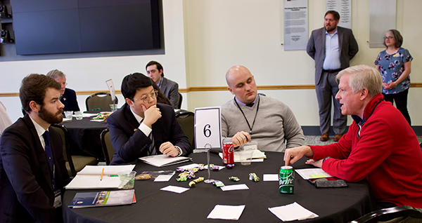 Paul Mayer (right) in red sweater fills in Foreign Service Day participants on the details of the life of a diplomat