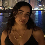 Nardine Eldalil in front of a cityscape at night.