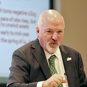 Terry Clower sitting and giving a presentation