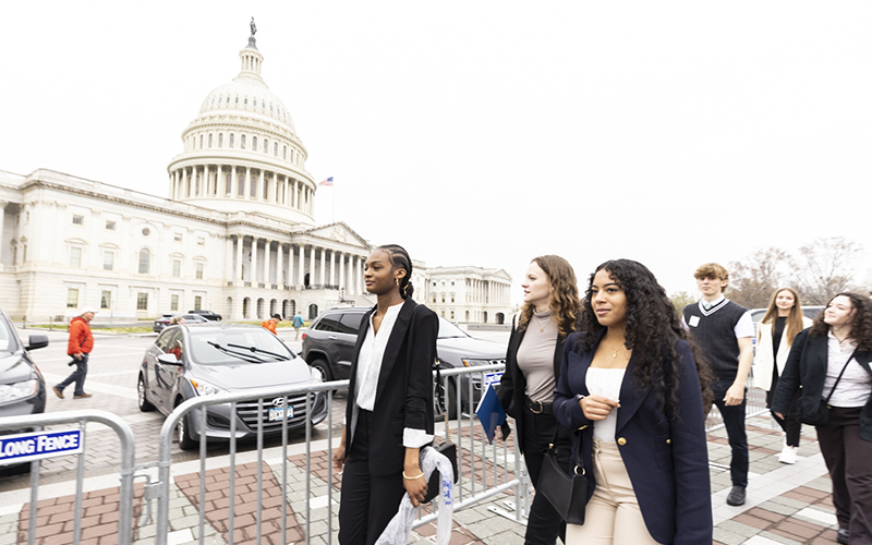 A group of students walks past the U.S. Capitol building in Washington, D.C.